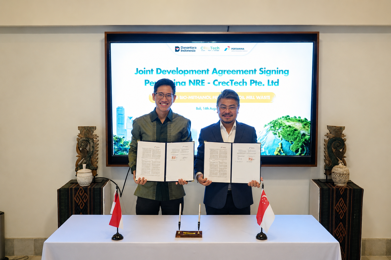Dr. Lim Kang Hui of CRecTech and Mr. John Anis of Pertamina NRE holding the signed Joint Development Agreement